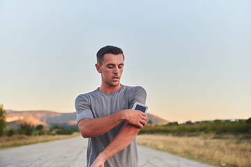 Image showing A young handsome man running in the early morning hours, driven by his commitment to health and fitness