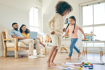 Image showing Big family, toys and children running with parents on a laptop .in lounge at home together for creative fun. Living room, happy and development of kids on carpet floor with games by mom and dad