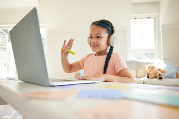 Image showing Laptop, elearning and child on a video call wave in a class doing homework in her bedroom at her house. Greeting, technology and kid student in a virtual online lesson for home school on a computer.