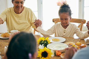 Image showing Praying, parents and child holding hands for lunch, dinner or breakfast together with grandparents at home. Family, religion and mother, dad and girl giving thanks, gratitude and prayer for food