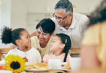 Image showing Happy, grandparents and children at table for lunch, dinner and meal together for celebration at home. Family, party and grandpa, grandmother and kids with food for bonding, gathering and holiday