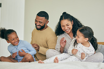 Image showing Family, playful and bed with children in morning for quality time on weekend in home with care. Happiness, parents and kids together for fun in bedroom with laugh or bonding for love with smile.