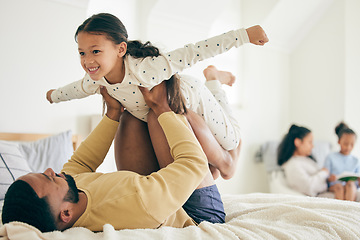 Image showing Happy family, airplane and father with girl child on a bed for playing, bond and relax in their home together. Flying, play and kid with parent in a bedroom with vacation freedom, wake up and smile