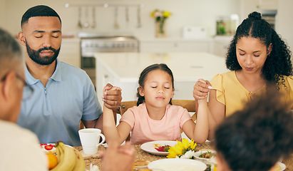 Image showing Praying, parents and child at table for lunch, dinner or breakfast together and holding hands for grace. Family, religion and mother, dad and girl giving thanks, gratitude and prayer for food at home