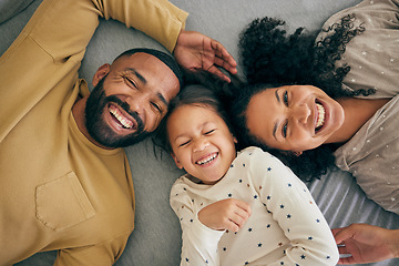 Image showing Happy family, above and kid smile or happy with parents together in the morning laughing in a bedroom on a bed. Relax, mom and dad enjoy quality time with kid with happiness, bonding and love