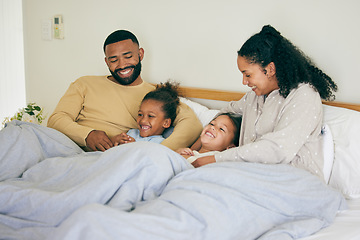 Image showing Happy family, wake up and playing in bed in the morning, bond and having fun in their home together. Love, bedroom and parents with children and tickle, game and laugh, play and cuddle on the weekend