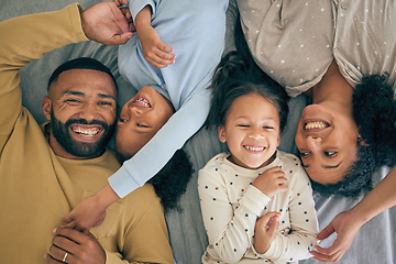 Image showing Happy family, top view and kids relax or happy with parents together in the morning laughing in bedroom on a bed. Lying, mom and dad enjoy quality time with children with happiness, above and love