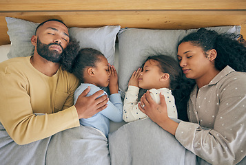 Image showing Sleeping, family and relax in bed from above, relax and resting in their home on the weekend. Sleeping, comfort and top view of parents embracing children in a bedroom with love, nap and dreaming