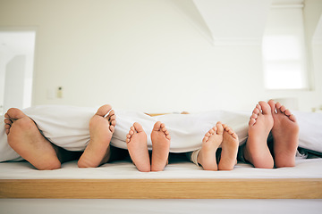 Image showing Sleep, feet and family in a bed relax, resting and enjoying a weekend nap in their home. Sleeping, foot and children with parents in bedroom for dreaming, stress relief or vacation freedom in a house