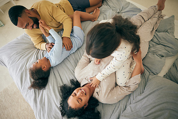 Image showing Happy family, from above and playing in bed in the morning, bond and having fun in their home together. Love, top view and children tickle parents in a bedroom, playful and relax in their house