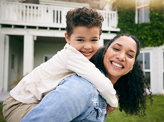 Image showing Mother, son and piggyback, portrait outdoor with love and bonding, relax on lawn at holiday home, fun and happiness. Playful, smile and trust, woman and boy in garden with hug on vacation and nature