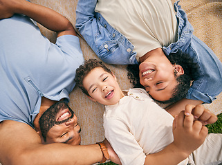 Image showing Happy family, above and relax at a park, bonding and enjoying the weekend outdoor. Top view, smile and boy child with parents on a field with freedom, love and vacation, care and chilling on lawn