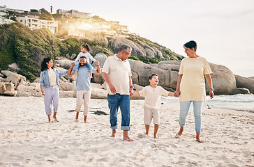 Image showing Big family, holding hands and walking at a beach for travel, vacation and fun in nature together. Freedom, parents and children relax with grandparents at the sea on holiday, trip or ocean adventure