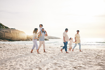 Image showing Holding hands, walking and big family at a beach for travel, vacation and fun in nature together. Freedom, parents and children relax with grandparents at the sea at sunset, trip or ocean holiday