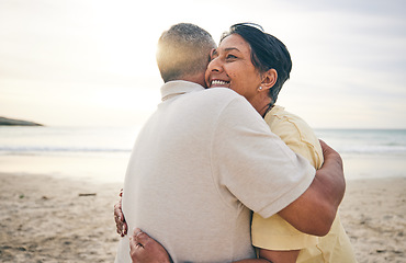 Image showing Hug, love and senior couple at beach happy, relax and bond in nature together. Ocean, embrace and old people hugging at the sea for travel, vacation and enjoy retirement with holiday, freedom or trip