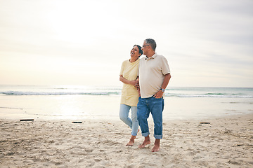 Image showing Walking, love and senior couple at beach happy, relax and bond in nature together. Ocean, embrace and old people at the sea for travel, vacation and enjoy retirement with holiday, freedom or walk