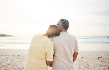 Image showing Sunrise, love and senior couple by beach for bonding, quality time and relaxing in nature. Morning, retirement and back of elderly man and woman embrace on vacation, holiday and travel by ocean