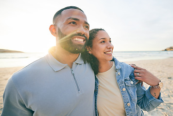 Image showing Sunrise, happy and couple hug by beach for bonding, quality time and love on holiday in nature. Morning, relationship and face of happy man and woman embrace on vacation, honeymoon and travel by sea