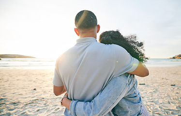 Image showing Couple hug, back and beach, ocean and travel with bond and love, trust and marriage outdoor. Adventure, tropical holiday and view of sea waves, man and woman with loyalty and life partner in nature