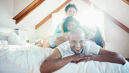 Image showing Pile, family and portrait in home bedroom, bonding and sunshine with lens flare. Face, happy and children with father, mother and parents on bed with love, care and quality time for game together.