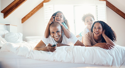 Image showing Funny, family portrait and watching tv in bedroom, bonding and sunshine with lens flare. Face, television and children with father, mother and happy parents relax in home, streaming movie and laugh.