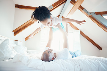 Image showing Father, daughter in air and games in bedroom, airplane and care free with bonding, love and happiness at family home. Man lifting young girl, playing together with fun and playful, trust and freedom