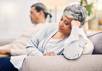 Image showing Senior couple, divorce and argument on sofa in conflict, fight or disagreement in living room at home. Elderly man and woman in stress, depression or toxic relationship for cheating affair or breakup