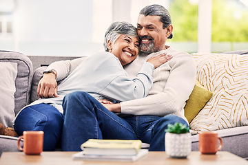 Image showing Happy, hug and senior couple relax on a sofa with love, bond and laugh with conversation. Old people, living room and embracing with smile, trust and soulmate connection while enjoying retirement