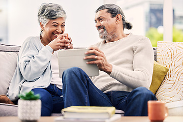 Image showing Tablet, senior and funny couple on sofa with comedy show, social media or online streaming service at home. Relax, couch and elderly woman, happy man or people laughing for digital tech and coffee