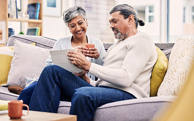 Image showing Tablet, love and senior couple browsing on social media, mobile app or the internet on sofa. Conversation, relax and mature man and woman networking on an online website in the living room at home.