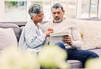 Image showing Tablet, relax and mature couple networking on social media, mobile app or the internet on sofa. Conversation, online and senior man and woman browsing on digital technology in the living room at home