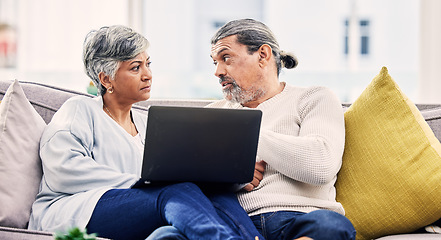 Image showing Senior couple, laptop and serious discussion on sofa for financial planning, budget or debt at home. Elderly man and woman talking with computer for finance, mortgage loan or crisis in living room