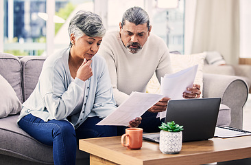 Image showing Senior couple, laptop and retirement paperwork, manage finance and investment at home. People do taxes online, pension policy documents and budget, serious woman and man with bills and life insurance