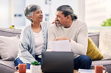 Image showing Happy couple, planning and documents on laptop for finance, taxes or retirement goals and investment at home. Talking, sofa and senior people on sofa, life insurance and asset management on computer