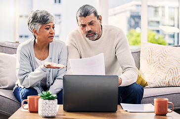 Image showing Senior couple, paperwork and stress on laptop with financial documents, taxes or retirement questions at home. Planning debt, computer and people on sofa for life insurance, bills or asset management