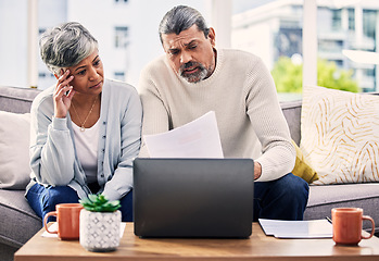 Image showing Documents, stress and senior couple on computer with finance paperwork, taxes or retirement research at home. Planning, debt and elderly people on sofa reading insurance, bills and asset management