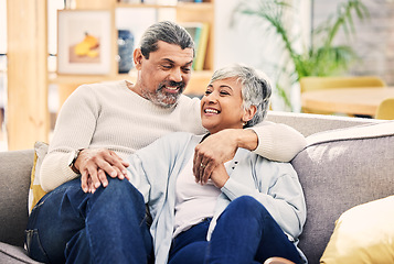 Image showing Home, speaking and senior couple on a couch, love or relax with happiness, marriage or quality time. Romantic, elderly woman or mature man on a sofa, relationship or joy with conversation in a lounge