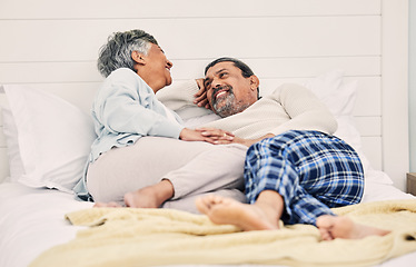 Image showing Talking, funny or old couple in bedroom to relax, enjoy romance or morning time together at home. Holding hands, senior woman or happy elderly man laughing or bonding with love, support or smile