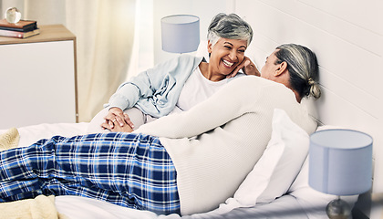 Image showing Happy, laugh and senior couple relax in bed with love, bond and holding hands with conversation. Old people, bedroom and speaking with smile, trust and soulmate connection while enjoying retirement
