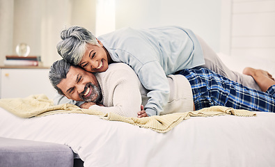 Image showing Lying, playful or old couple in bedroom to relax, enjoy romance or morning time together at home. Hugging, silly senior woman or happy elderly man laughing or bonding with love or smile in retirement