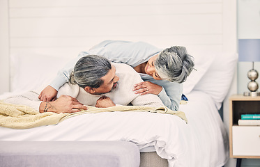 Image showing Senior couple, laugh and play on bed in home, hotel and happy together with romance, game and comic joke. Elderly woman, old man and funny on vacation, holiday and relax in bedroom, bonding and love