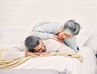 Image showing Happy senior couple, bed and laying in home, hotel and together for romance, chat or conversation in morning. Elderly woman, old man and talk on vacation, holiday or relax in bedroom, bonding or love