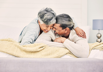 Image showing Lying, love or old couple in bedroom to relax, enjoy romance or morning together at home. Hugging, silly and senior woman with happy elderly man laughing or bonding with joke or smile in retirement