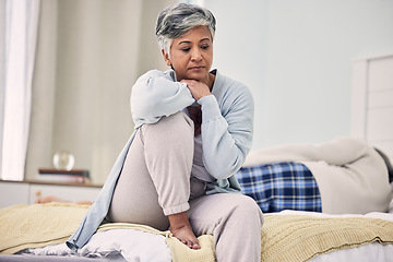 Image showing Divorce, sad and senior woman with depression in bedroom or frustrated with problem or fear. Infidelity, marriage and fight with elderly female with stress in home or angry with partner or couple.