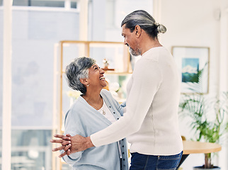 Image showing Happy senior couple, holding hands and dancing in living room for love, care or bonding together at home. Elderly man and woman enjoying quality time, weekend or holiday celebration for anniversary