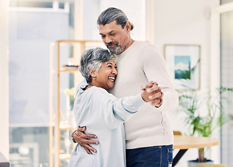 Image showing Happy senior couple, holding hands and dance in living room for love, care or bonding together at home. Elderly man and woman hug enjoying quality time, retirement or celebration for anniversary