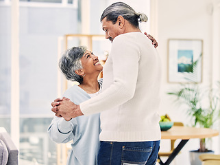 Image showing Senior couple, hug and holding hands in dance for love, care or bonding together in living room at home. Elderly man and woman enjoying quality time, weekend or holiday celebration for anniversary