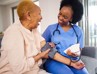 Image showing Black woman, nurse and caregiver for blood pressure, elderly care or healthcare on sofa at home. African female person or medical professional helping or monitoring old age patient in living room