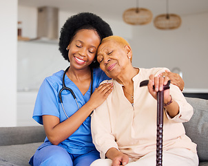 Image showing Black woman, nurse and senior patient in elderly care, hug and healthcare on living room sofa at home. Happy African medical professional or caregiver help person with kindness and cane in house