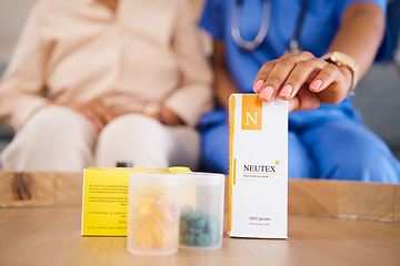 Image showing Box, hands and medicine with doctor, patient and table in home for wellness, healthcare and advice. Medic, pills and package in consultation, helping and pharmaceutical product for health in house